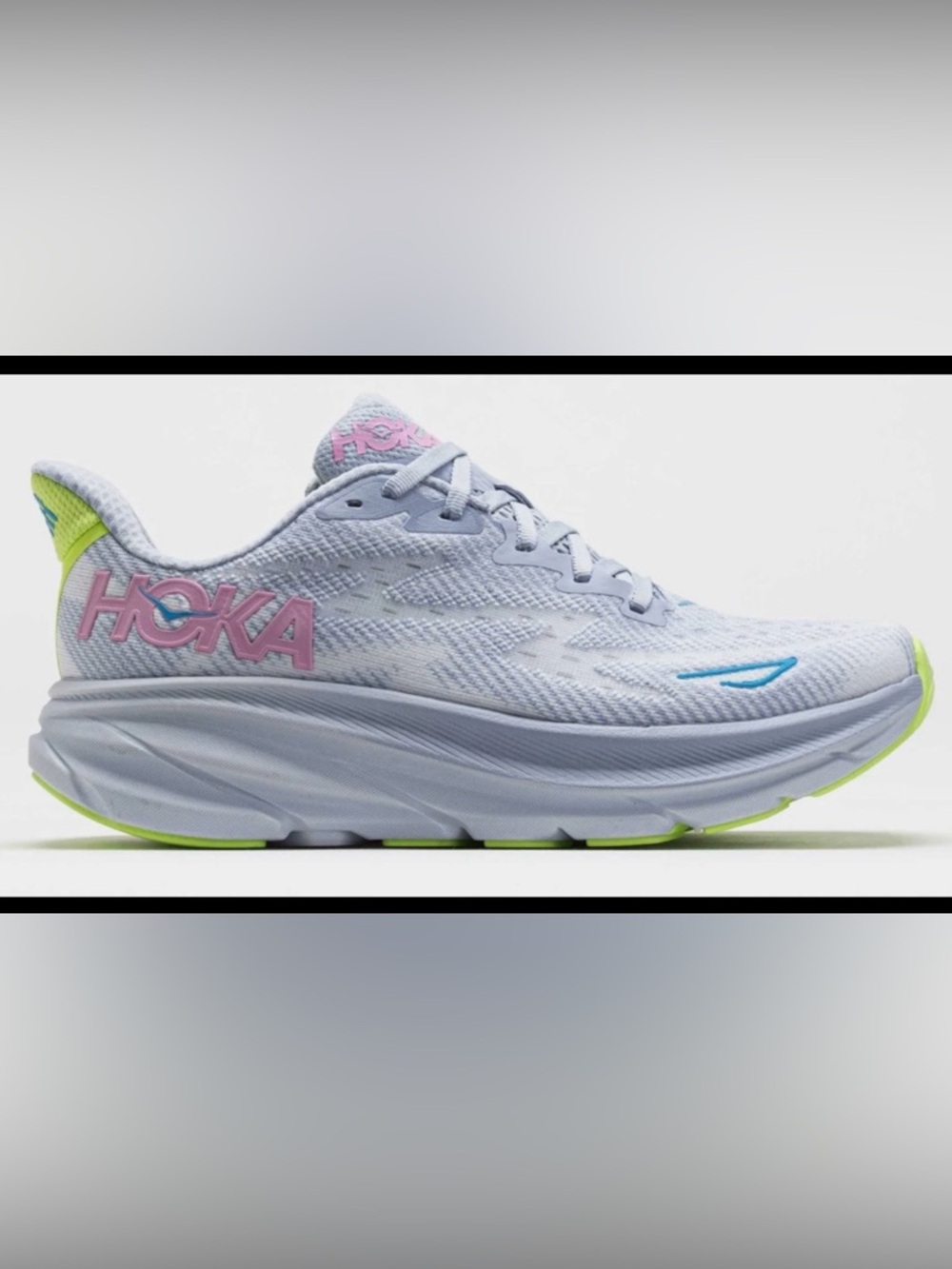 Hoka pale gray running sneakers with pink logo and blue accents